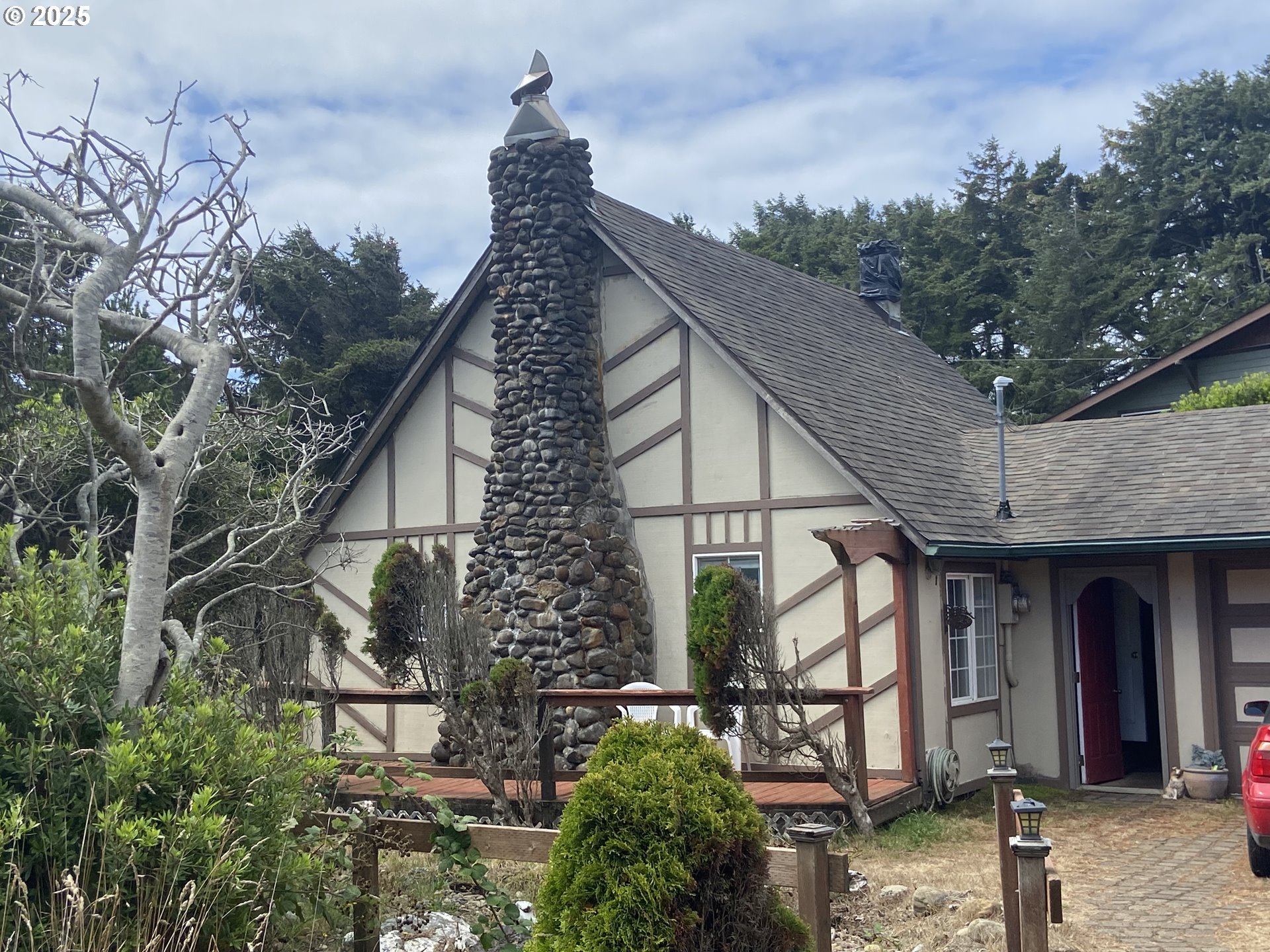a pathway of a house with large trees