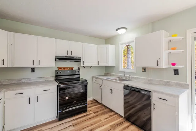 a kitchen with stainless steel appliances granite countertop a stove and a sink