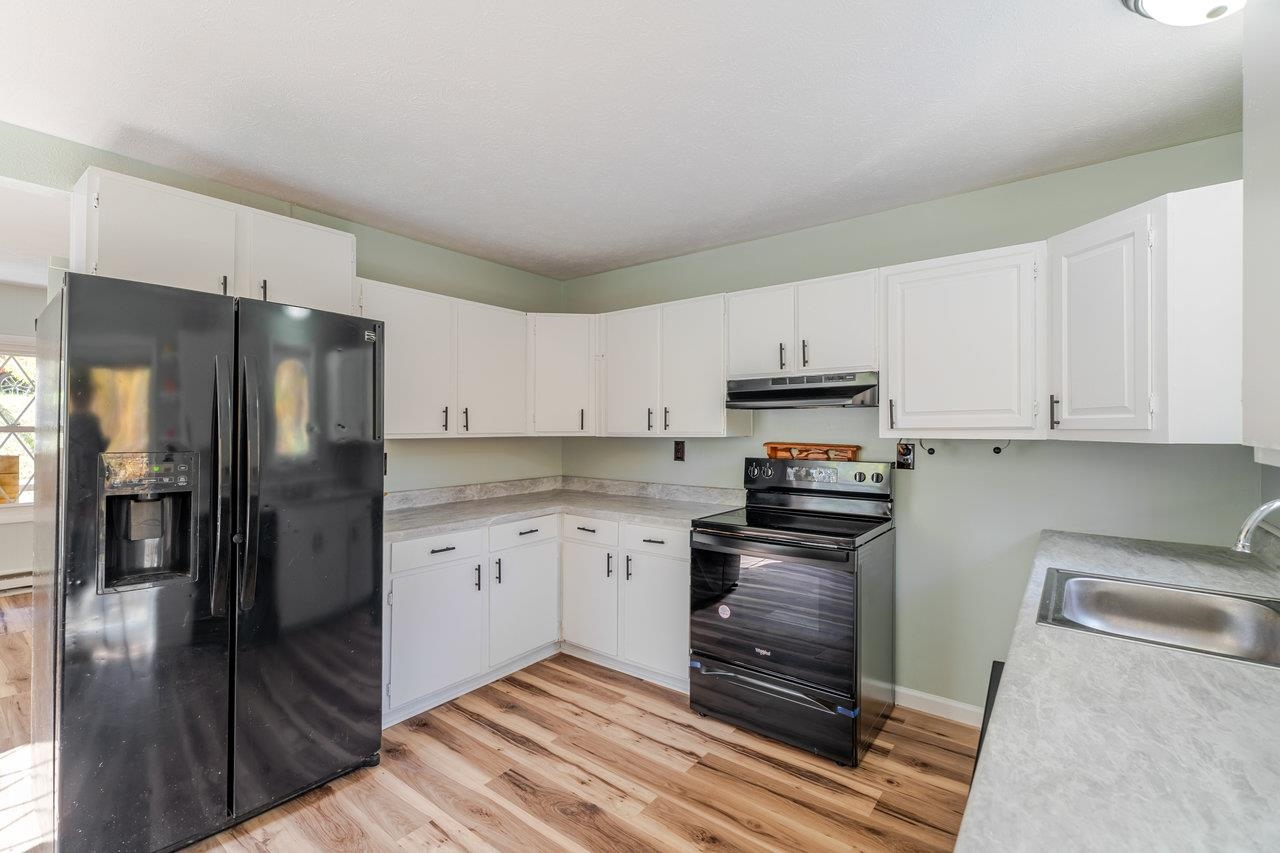 115 Risk Road Mount Jackson, VA 22842 - Photo 12 of 50 a kitchen with granite countertop a refrigerator stove and white cabinets
