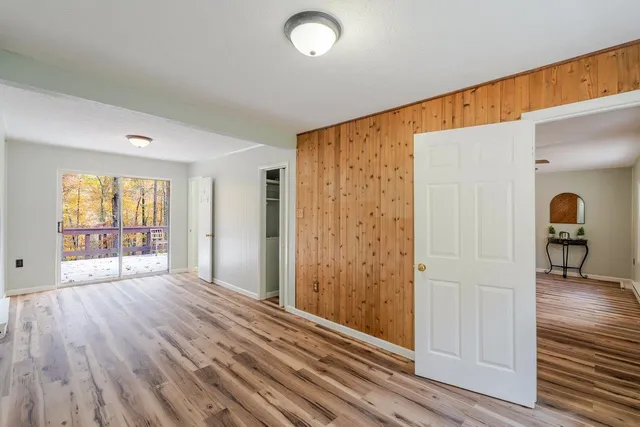 wooden floor in an empty room with a window