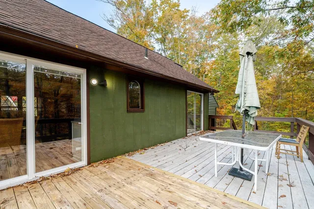 a backyard of a house with a table and chairs