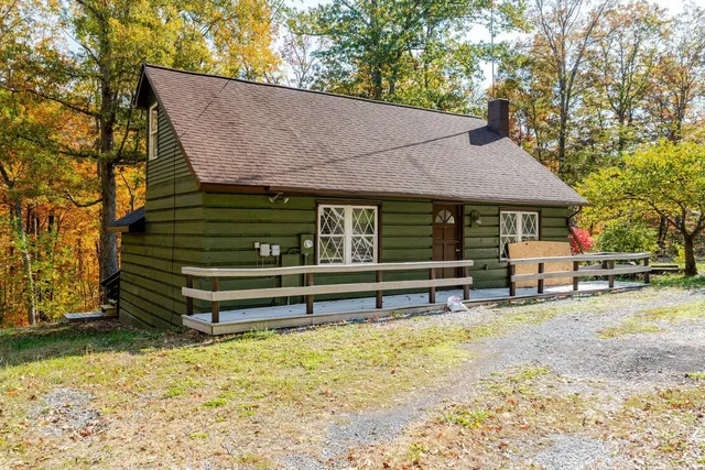 a view of a house with a yard and sitting area