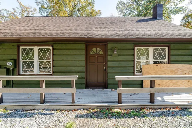 a front view of a house with a garden