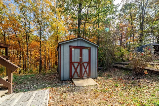 a view of barn with large windows and a small yard
