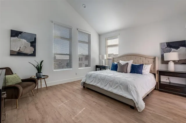 a bedroom with a bed a table and chair