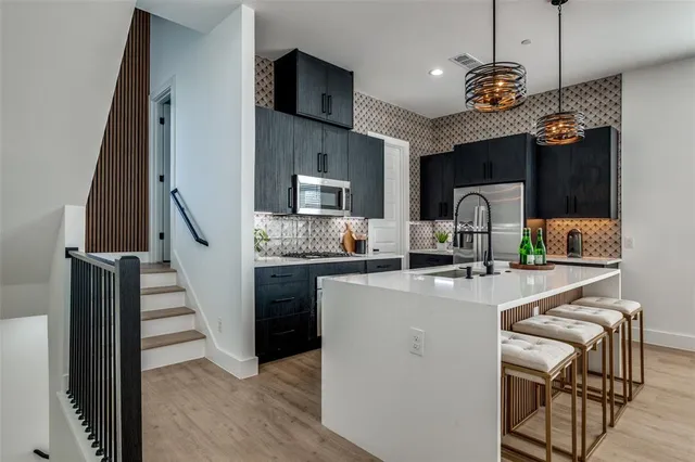 a kitchen with sink cabinets and wooden floor
