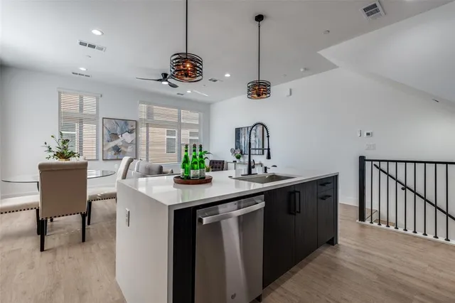 a kitchen with a counter space a sink and living room view
