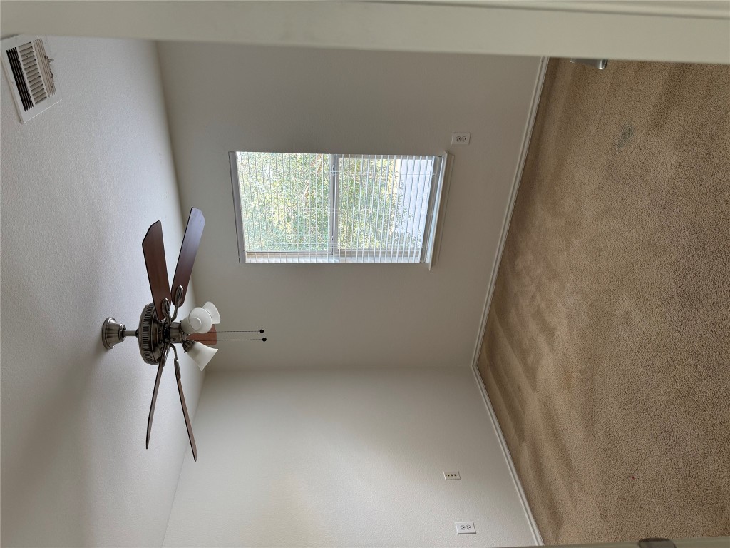 5609 Viewpoint Drive Austin, TX 78744 - Photo 15 of 21 an empty room with a window and a fan