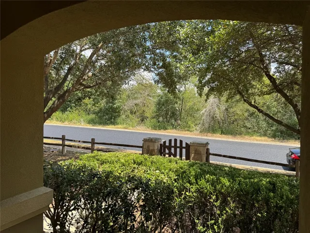 a view of a back yard from a balcony
