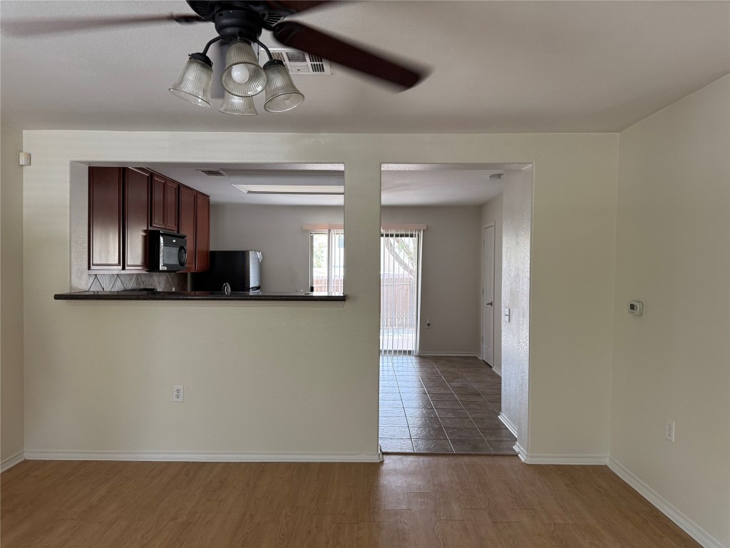 5609 Viewpoint Drive Austin, TX 78744 - Photo 6 of 21 a view of a hallway with wooden floor and chandelier