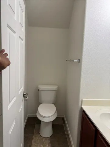 a white toilet sitting next to a sink
