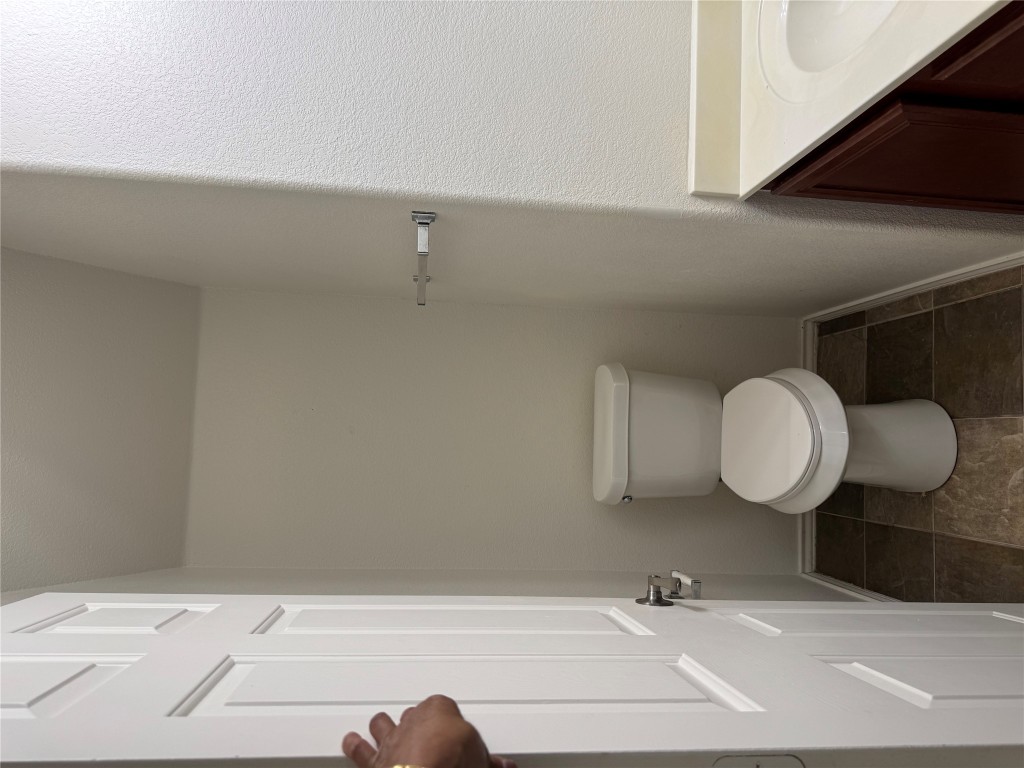 5609 Viewpoint Drive Austin, TX 78744 - Photo 10 of 21 a white toilet sitting next to a sink