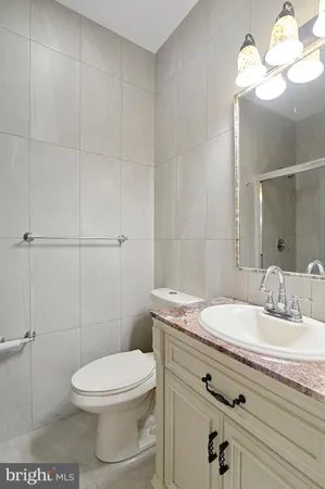 a bathroom with a sink a toilet and vanity