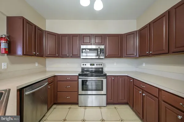 a kitchen with stainless steel appliances granite countertop a stove and a sink