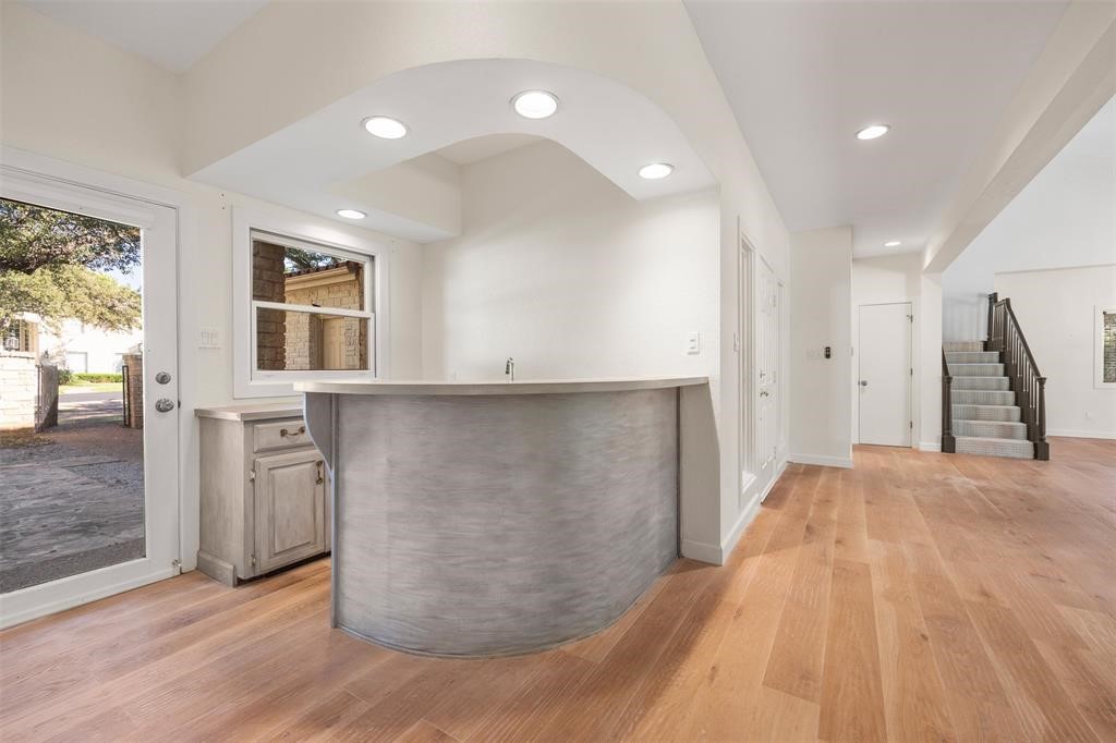 6 Sunview Road The Hills, TX 78738 - Photo 3 of 19 a view of a kitchen with furniture and wooden floor