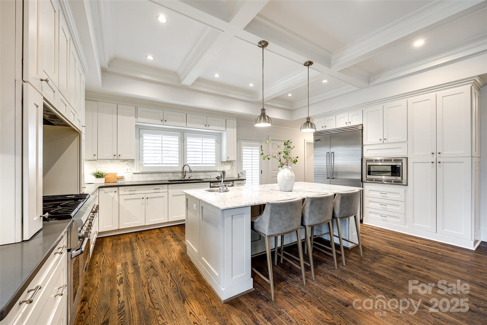 1225 Providence Road Charlotte, NC 28207 - Photo 15 of 42 a large white kitchen with a center island appliances and cabinets