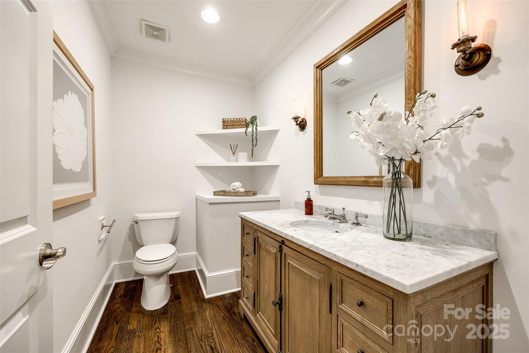 1225 Providence Road Charlotte, NC 28207 - Photo 19 of 42 a bathroom with a sink a toilet and a mirror