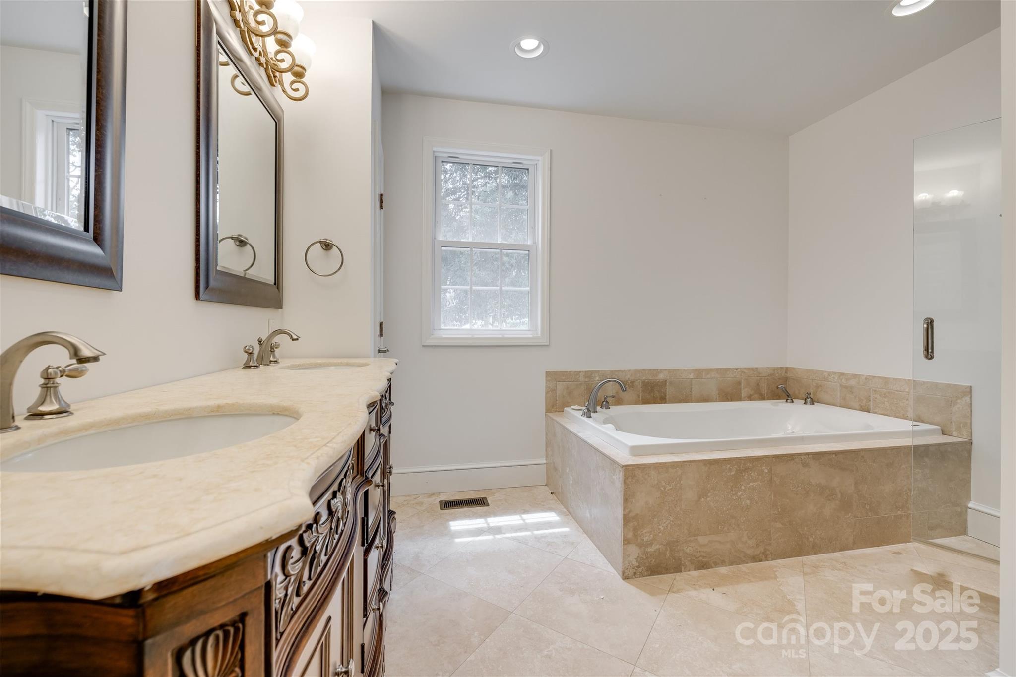 1225 Providence Road Charlotte, NC 28207 - Photo 22 of 42 a spacious bathroom with a tub sink and mirror