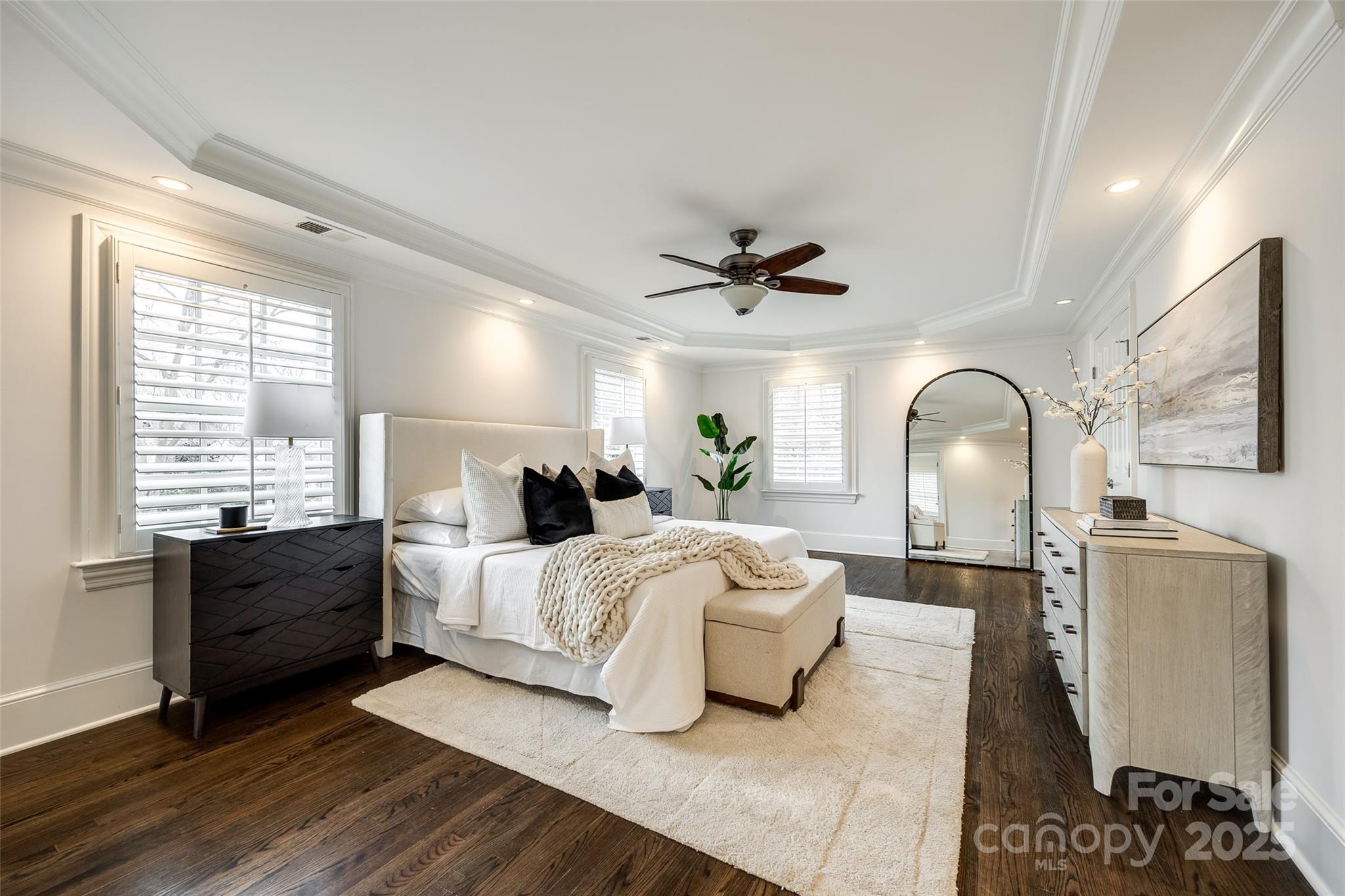 1225 Providence Road Charlotte, NC 28207 - Photo 24 of 42 a large bedroom with a bed and wooden floor