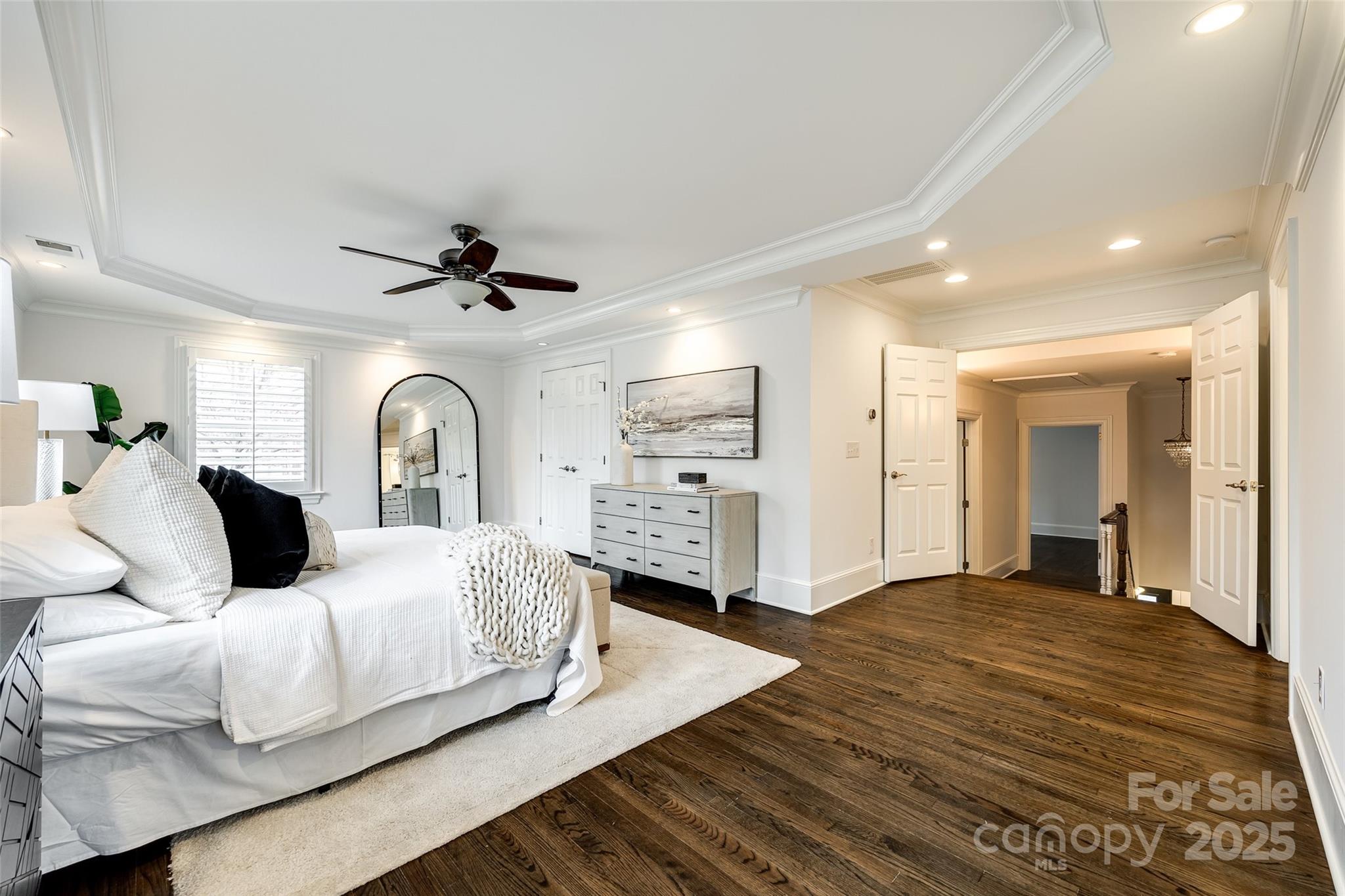 1225 Providence Road Charlotte, NC 28207 - Photo 26 of 42 a spacious bedroom with a bed and a ceiling fan