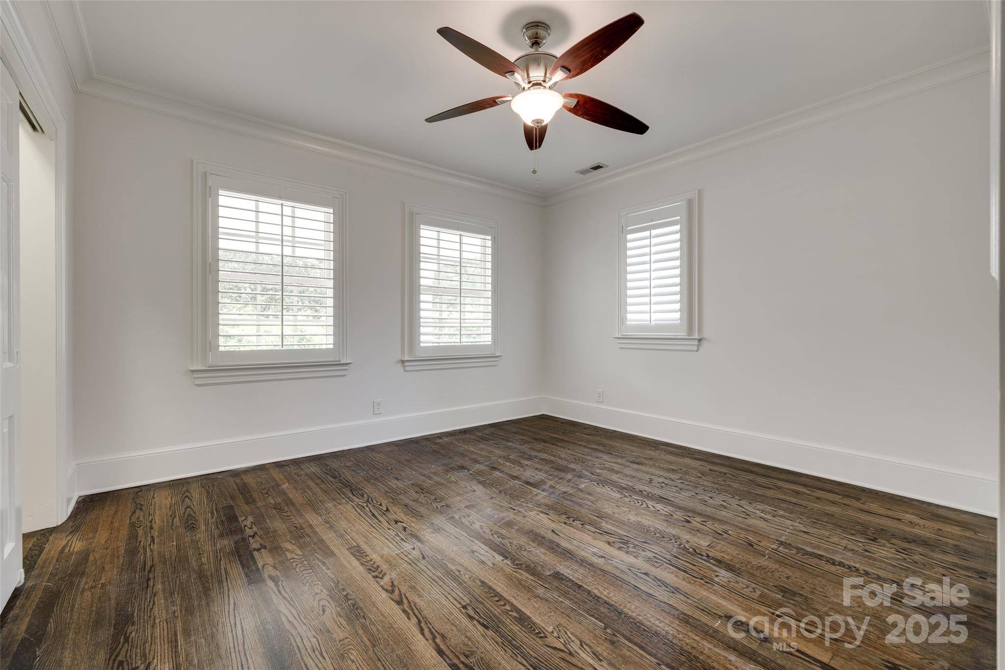1225 Providence Road Charlotte, NC 28207 - Photo 33 of 42 an empty room with wooden floor and windows