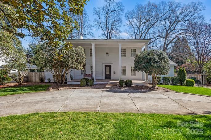 1225 Providence Road Charlotte, NC 28207 - Photo 35 of 42 a front view of a house with a yard and trees