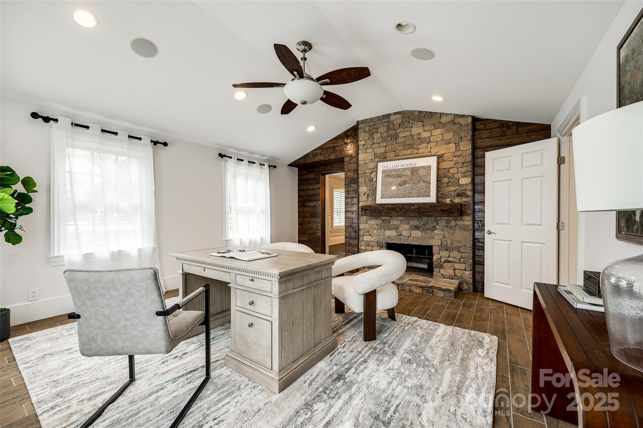 1225 Providence Road Charlotte, NC 28207 - Photo 8 of 42 a living room with furniture a fireplace and a large window