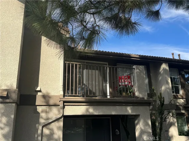 a view of house with outdoor space and tub
