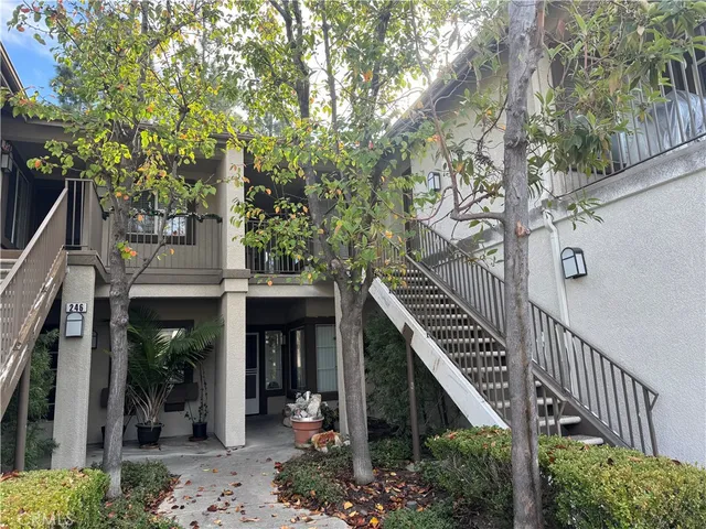 a front view of a house with a tree
