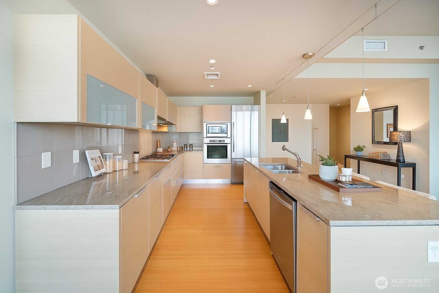 737 Olive Way, Unit 2908 Seattle, WA 98101 - Photo 12 of 35 a large kitchen with kitchen island a sink a counter top space a stove and a refrigerator