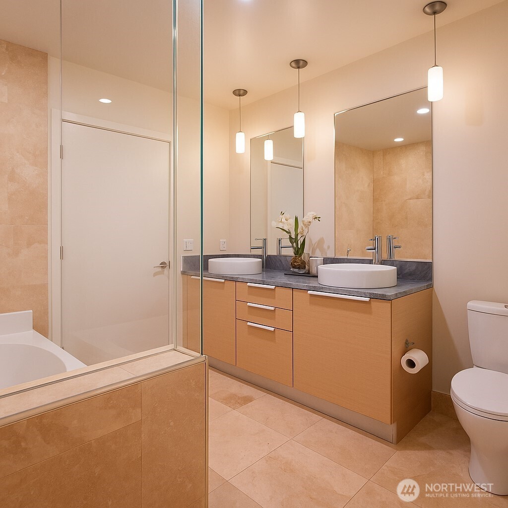 737 Olive Way, Unit 2908 Seattle, WA 98101 - Photo 15 of 35 a bathroom with a sink a toilet and shower