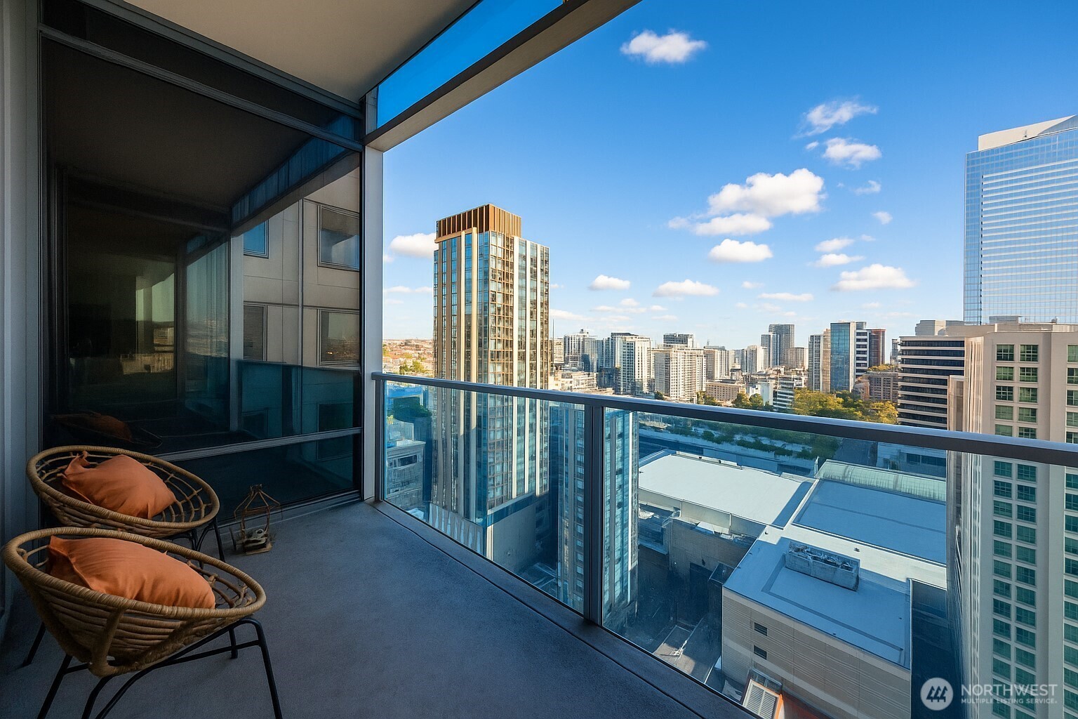 737 Olive Way, Unit 2908 Seattle, WA 98101 - Photo 19 of 35 a view of a balcony with chair and table