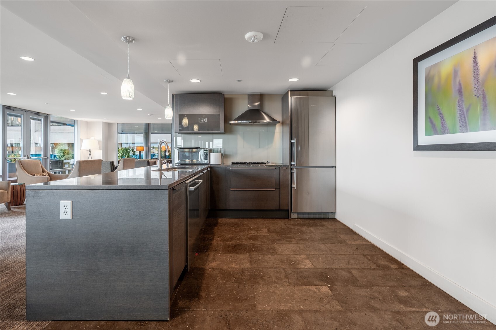 737 Olive Way, Unit 2908 Seattle, WA 98101 - Photo 24 of 35 a kitchen with stainless steel appliances granite countertop a refrigerator a sink a stove and a microwave
