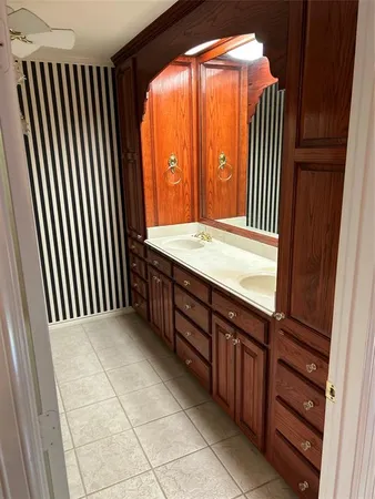 a spacious bathroom with a granite countertop sink a vanity and a mirror