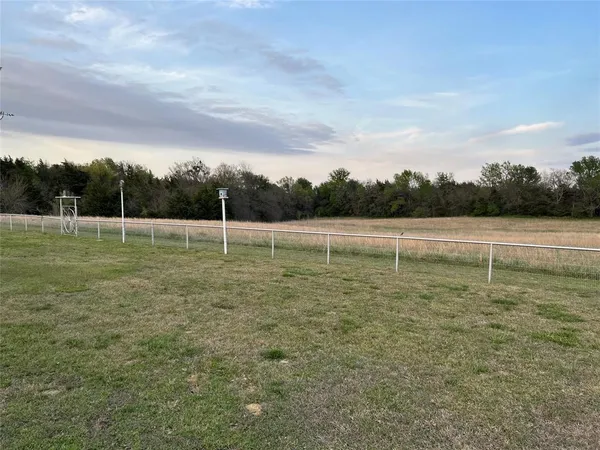 a view of outdoor space with swimming pool and trees in the background