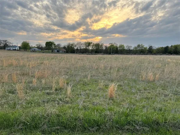 a view of a lake with houses in the back
