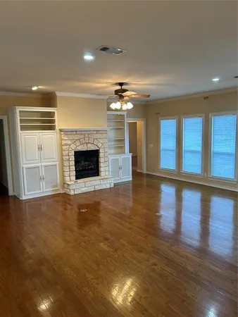 a living room with stainless steel appliances kitchen island granite countertop a stove a sink and white cabinets