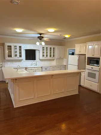 a large kitchen with kitchen island a sink stainless steel appliances and cabinets