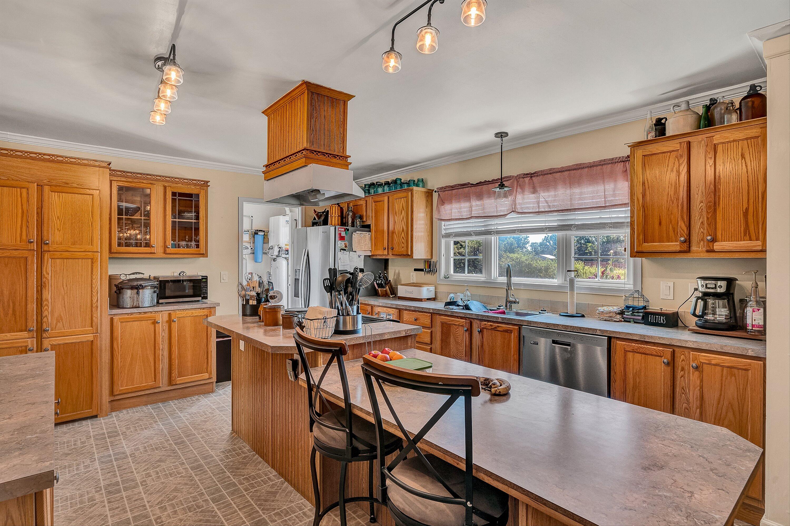 159 Simmons Creek Road Union Hall, VA 24176 - Photo 11 of 55 a kitchen with stainless steel appliances granite countertop table chairs sink and cabinets