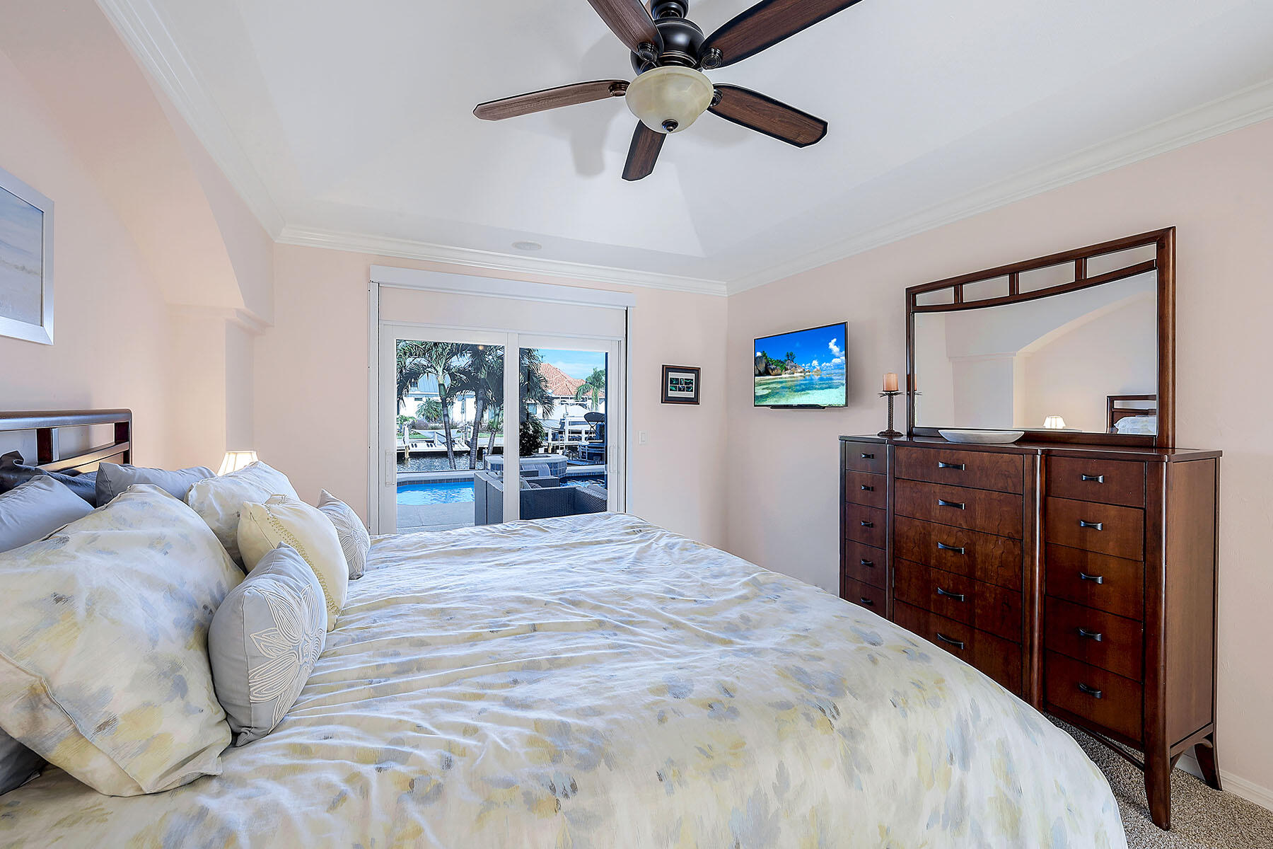 409 Waterleaf Court Marco Island, FL 34145 - Photo 15 of 38 a bedroom with a bed and a dresser