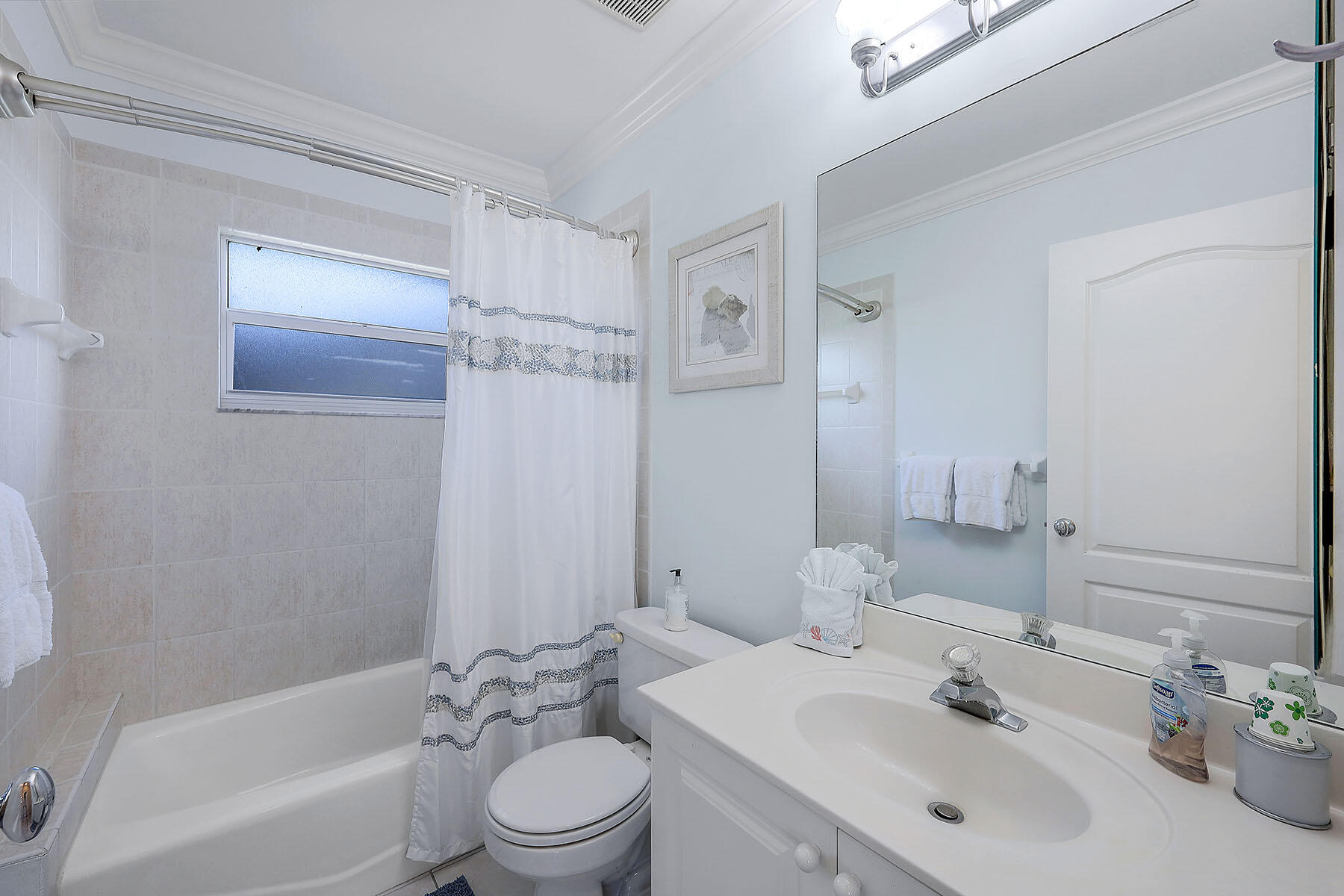 409 Waterleaf Court Marco Island, FL 34145 - Photo 19 of 38 a bathroom with a bathtub shower sink mirror vanity and toilet