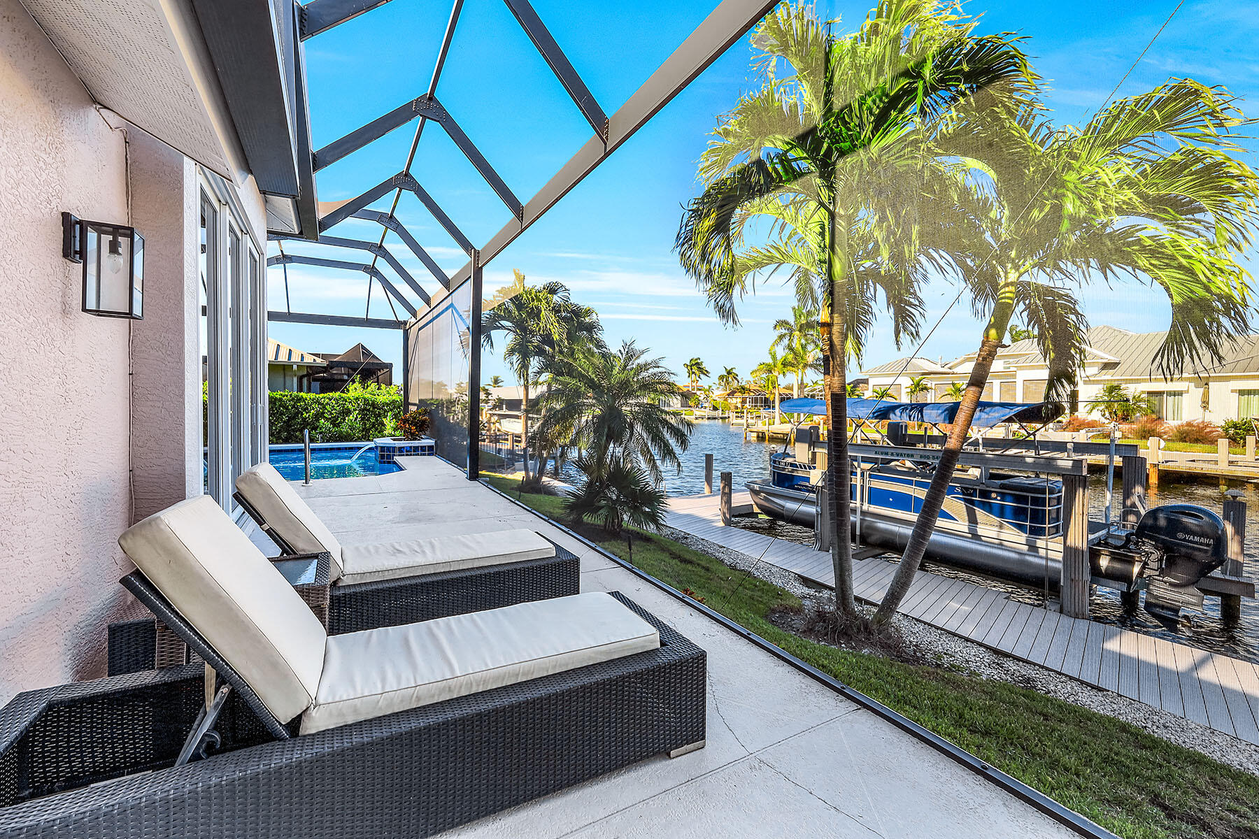 409 Waterleaf Court Marco Island, FL 34145 - Photo 28 of 38 a view of a patio with couches and table and chairs and potted plants