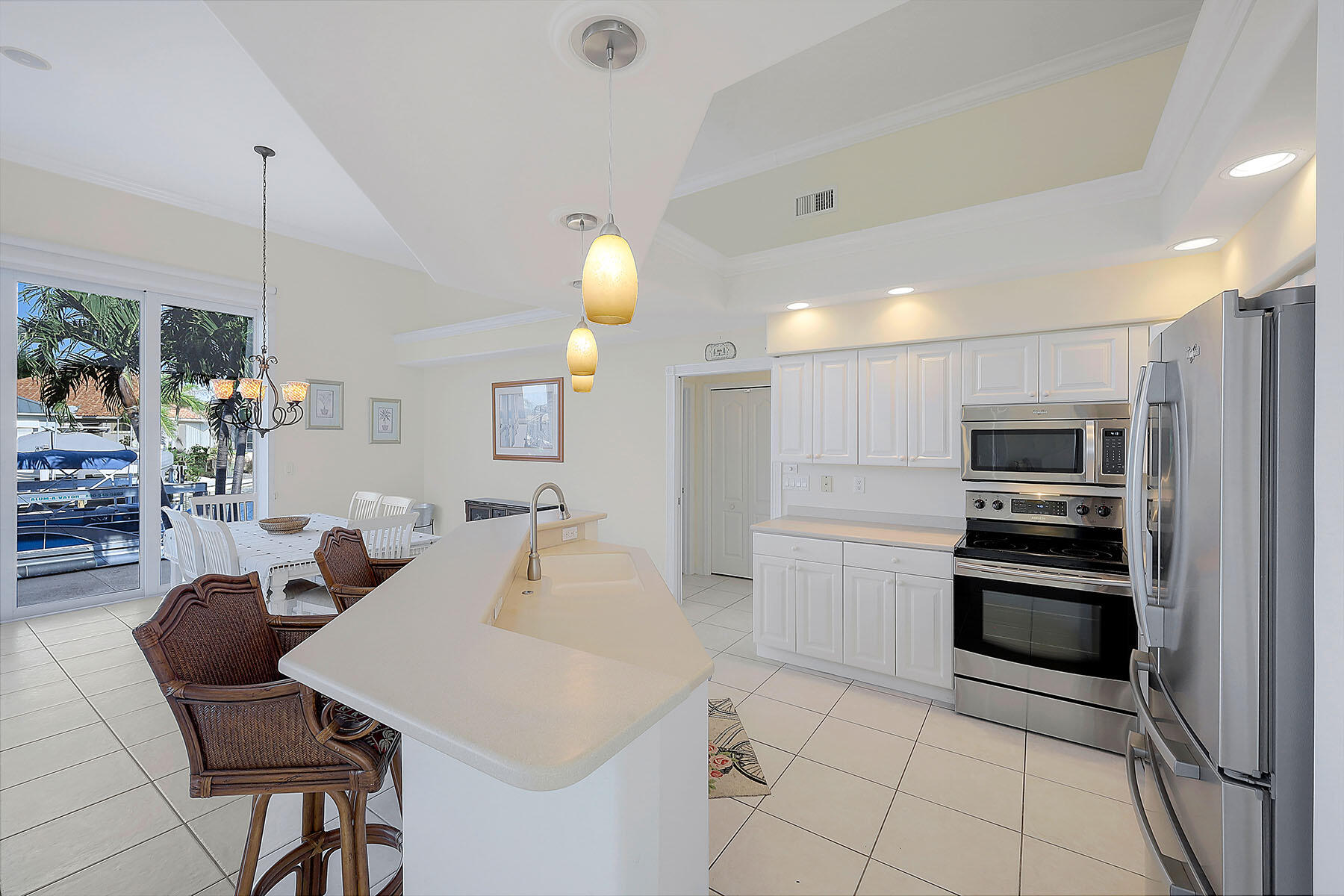 409 Waterleaf Court Marco Island, FL 34145 - Photo 7 of 38 a kitchen with stainless steel appliances kitchen island granite countertop a sink and cabinets