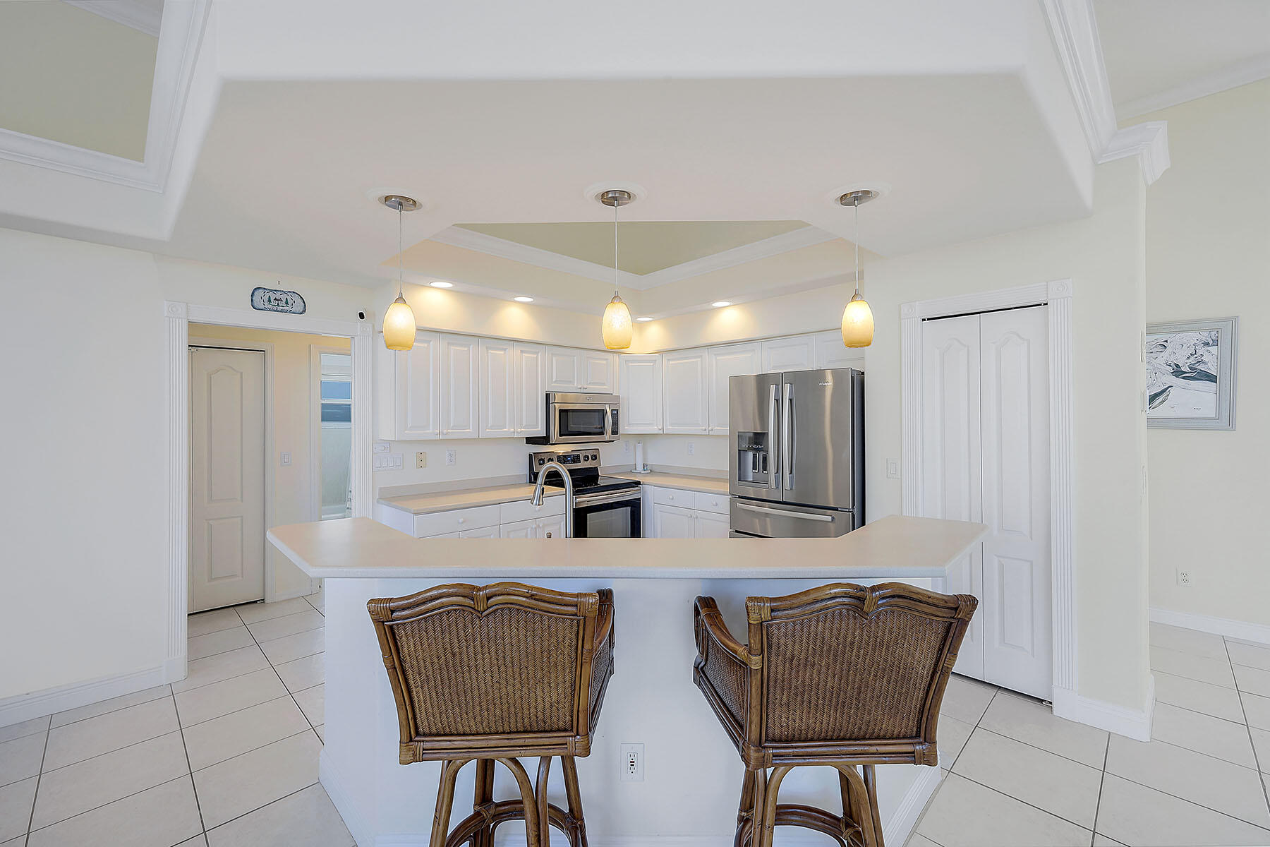 409 Waterleaf Court Marco Island, FL 34145 - Photo 8 of 38 a kitchen with stainless steel appliances kitchen island granite countertop a refrigerator and a stove