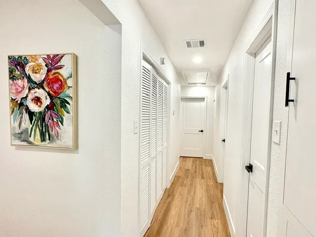 a view of a hallway with paintings on the wall