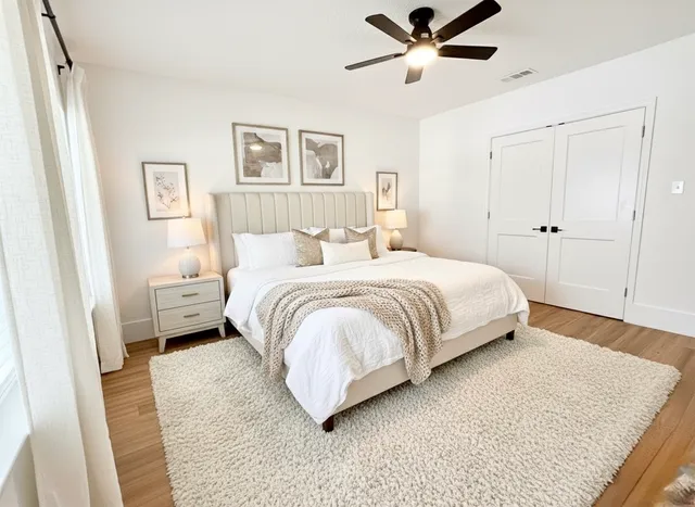 a bedroom with a bed and a painting on the wall