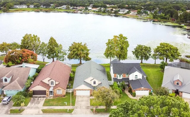 an aerial view of a house with a lake view