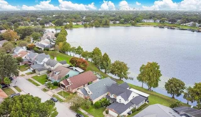 an aerial view of residential houses with outdoor space and ocean view
