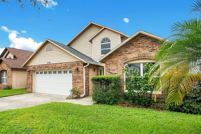 a view of a house with a yard and plants
