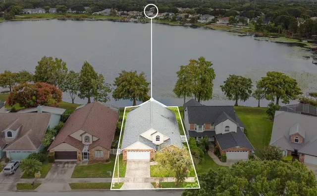 an aerial view of a house with outdoor space and lake view